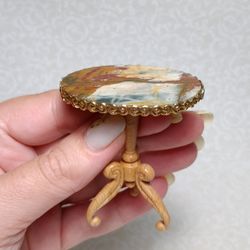 Dollhouse table in 1:12 scale. Oval miniature table with a stone top.