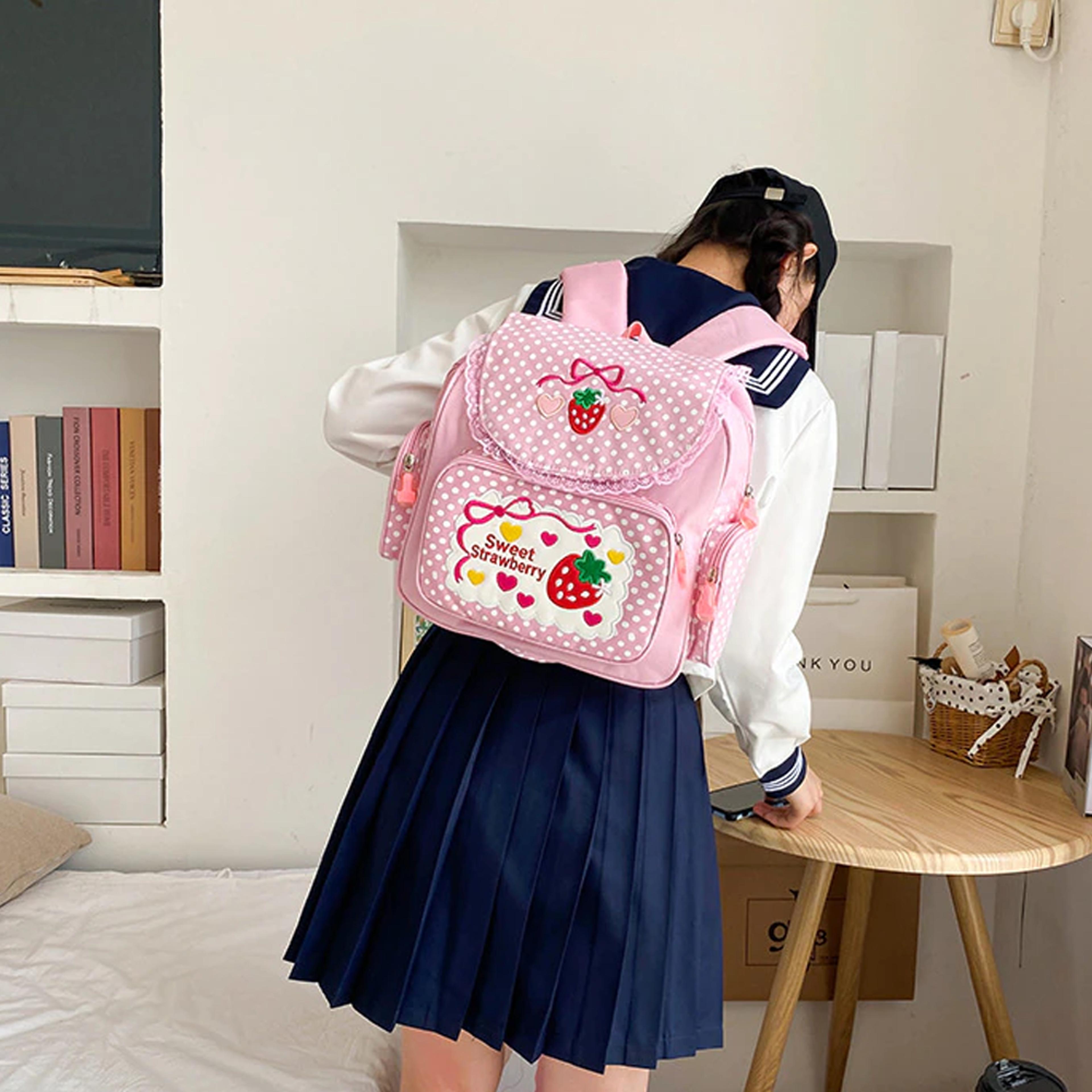 pink backpack with strawberry pattern