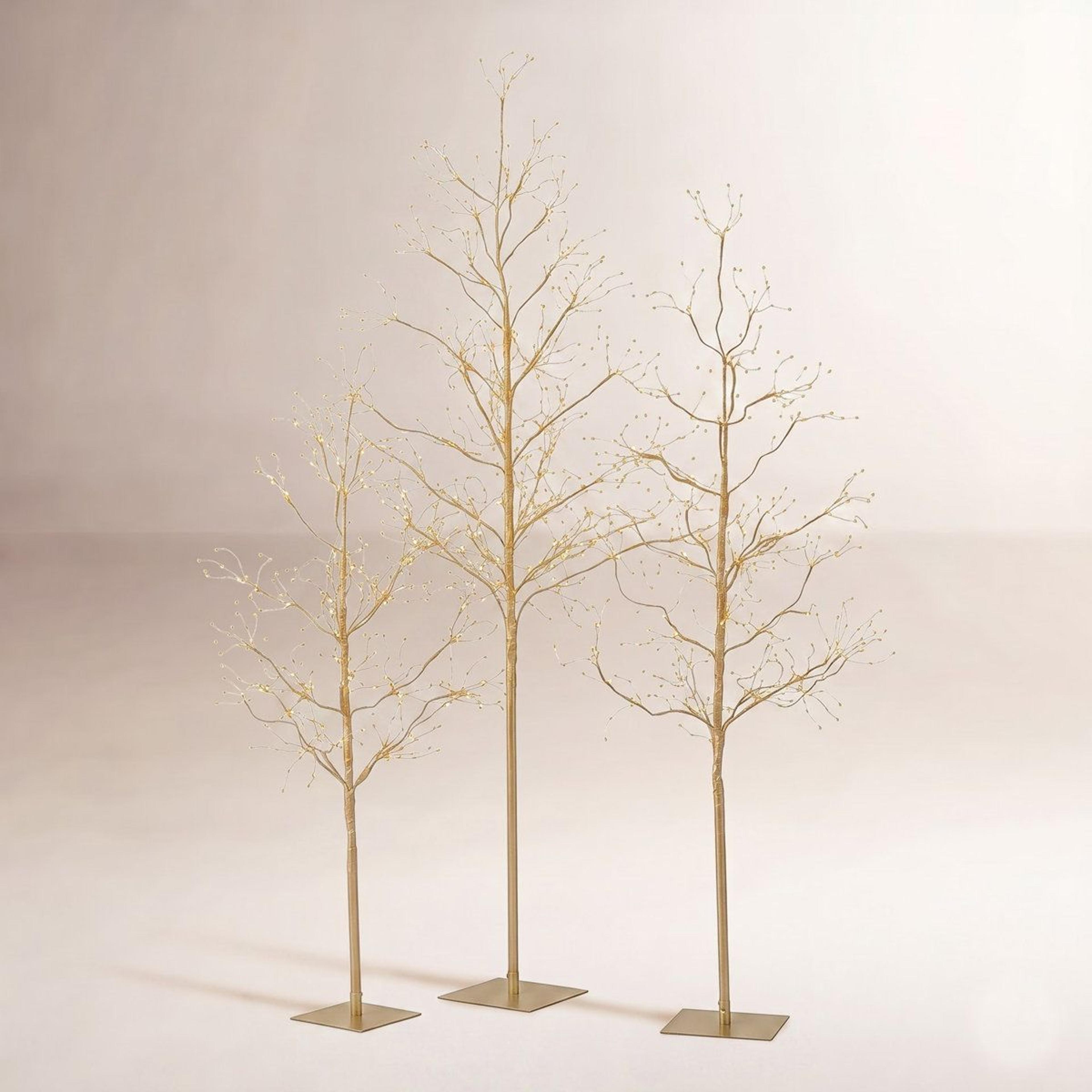 lighted tree set with gold lights for indoor and outdoor holiday decor