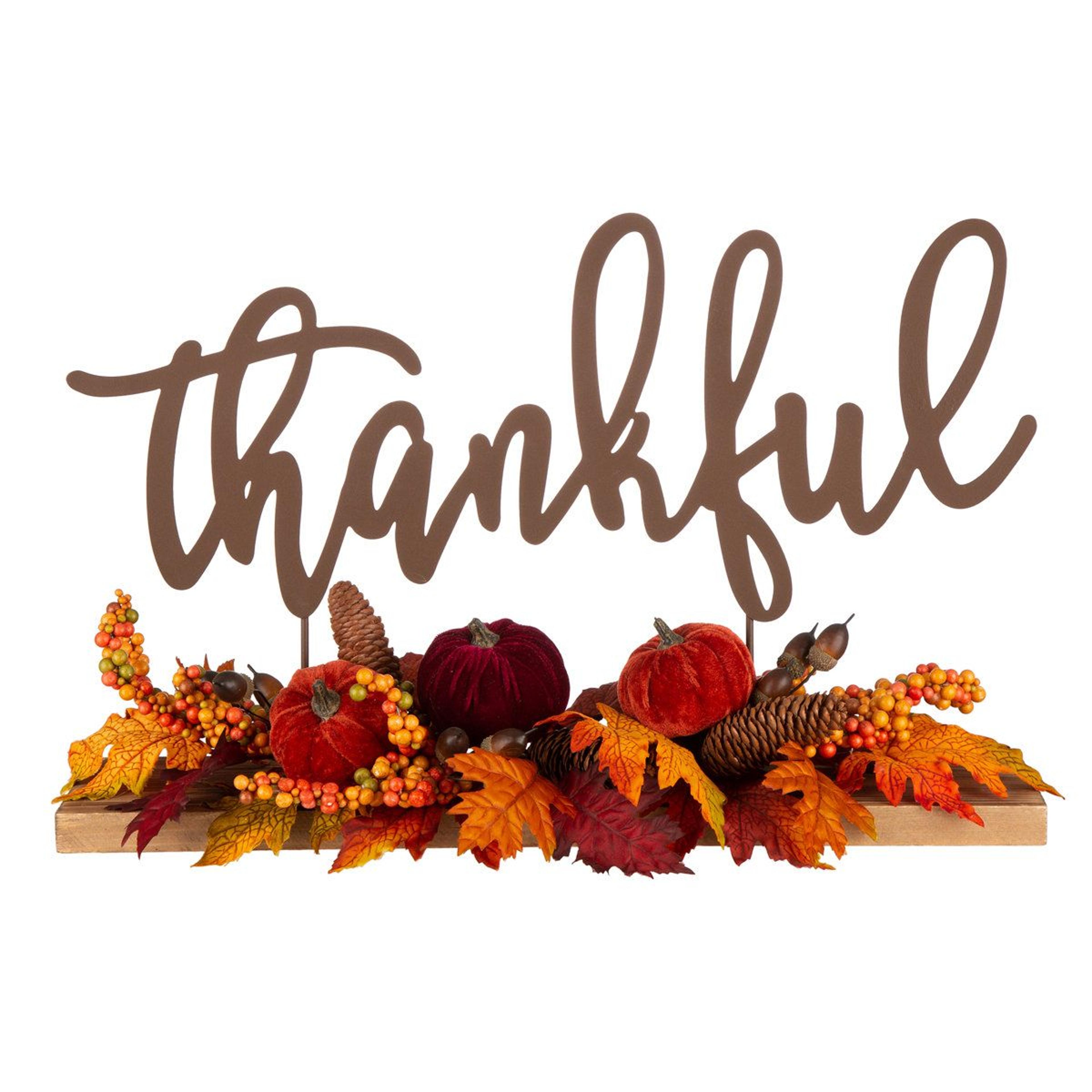 harvest thanksgiving centerpiece with pumpkins pinecones and fall leaves