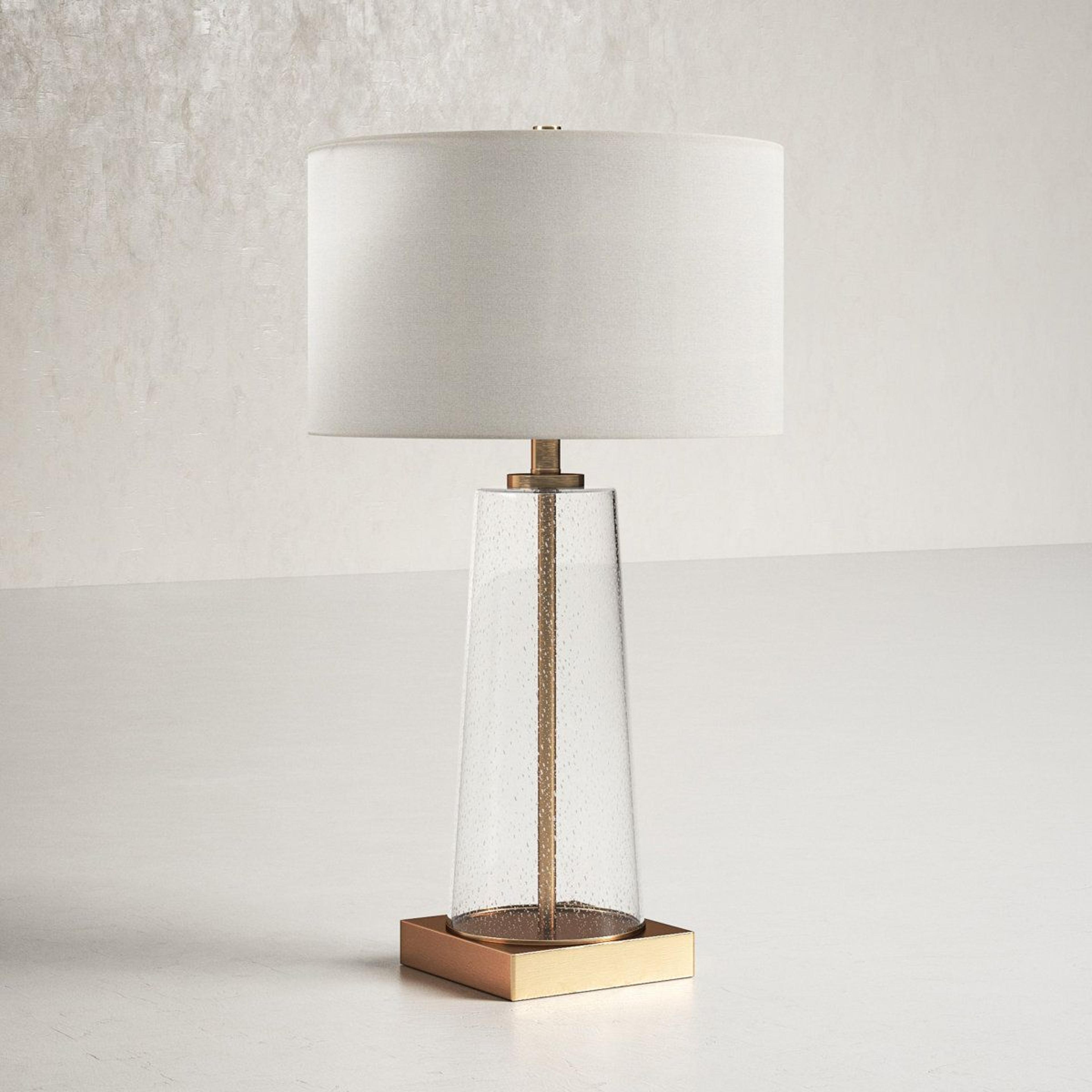 27.5 inch metal and glass table lamp with white drum shade