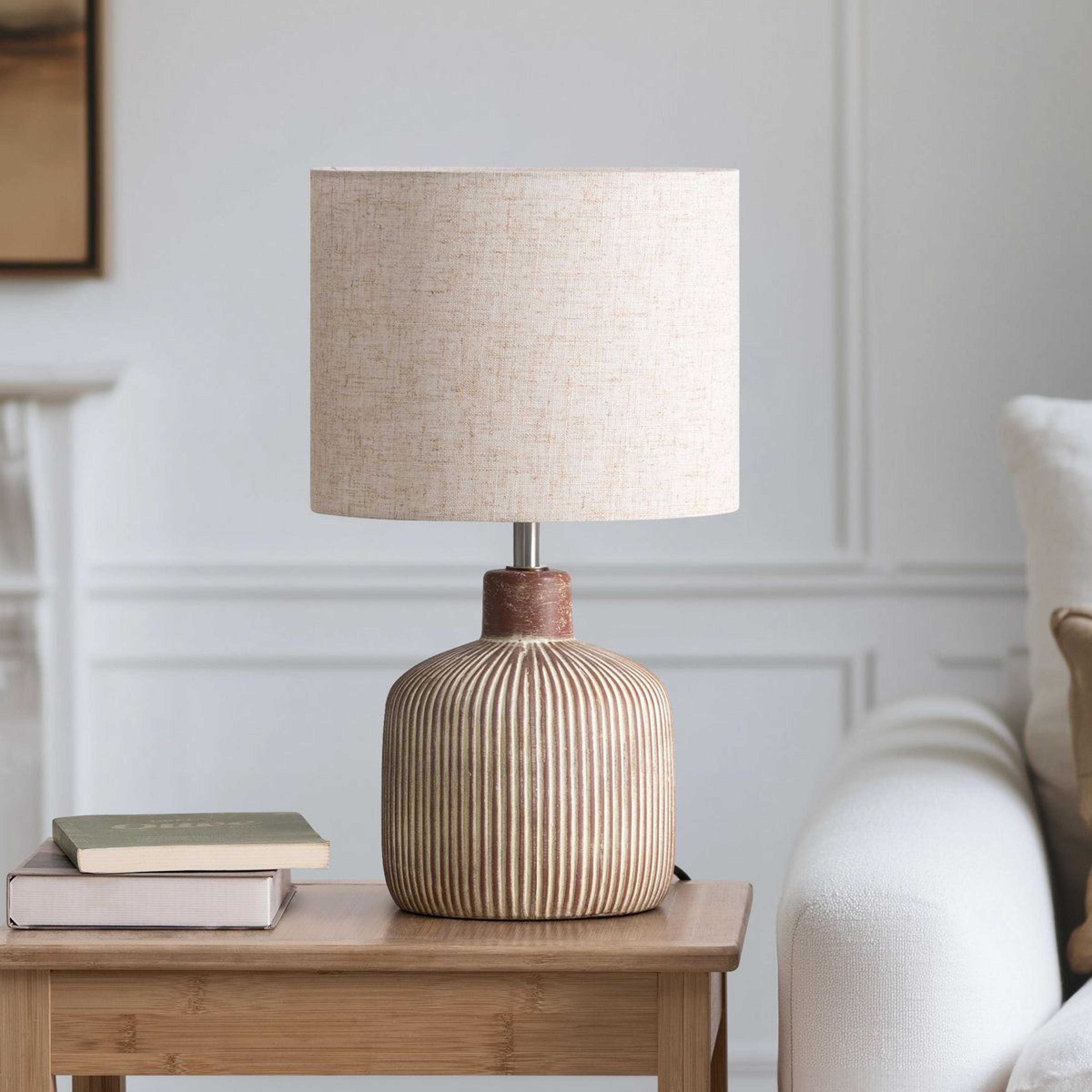 ceramic table lamp with linen shade and distressed stripe base