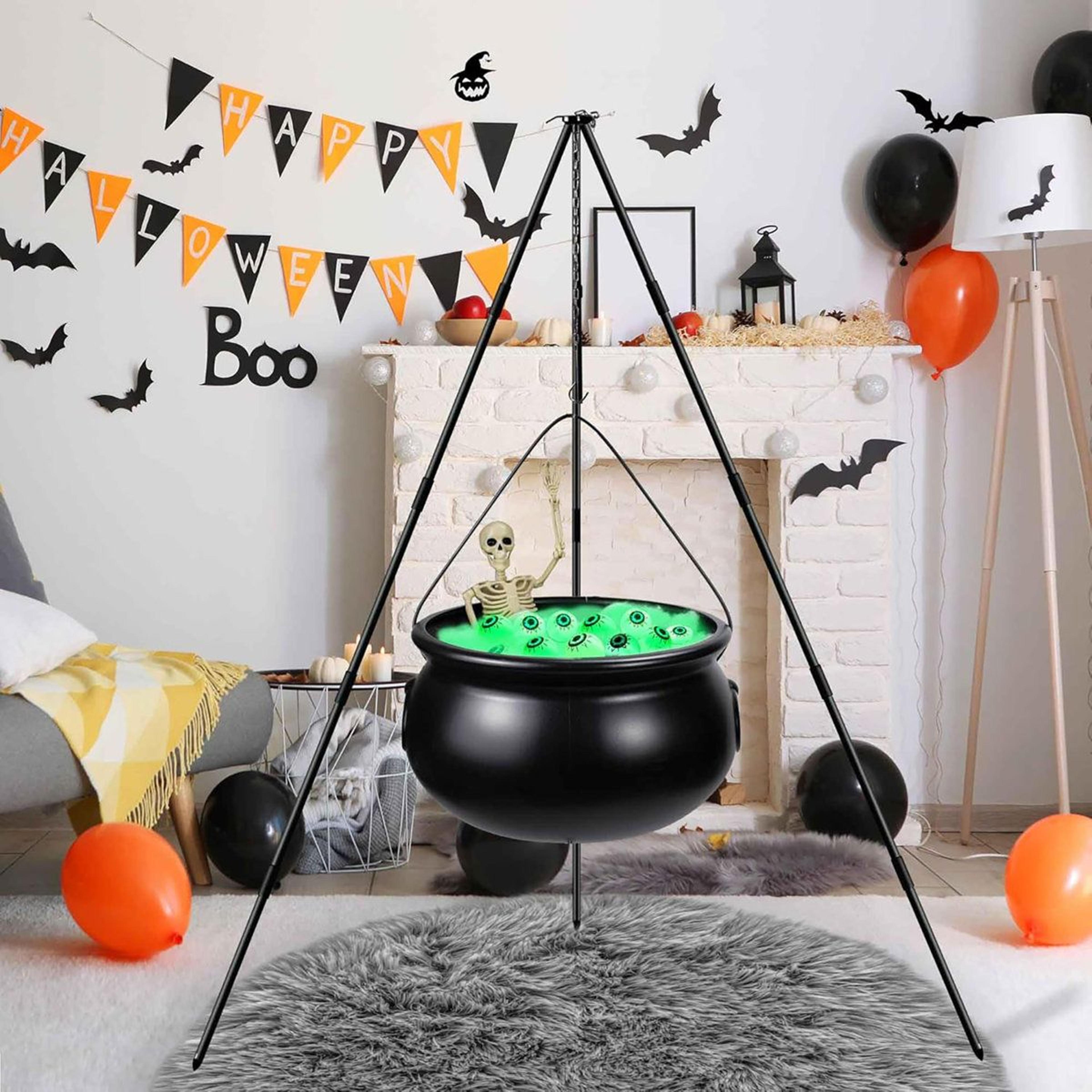 halloween witch cauldron decoration with tripod skeleton and green eyeball lights