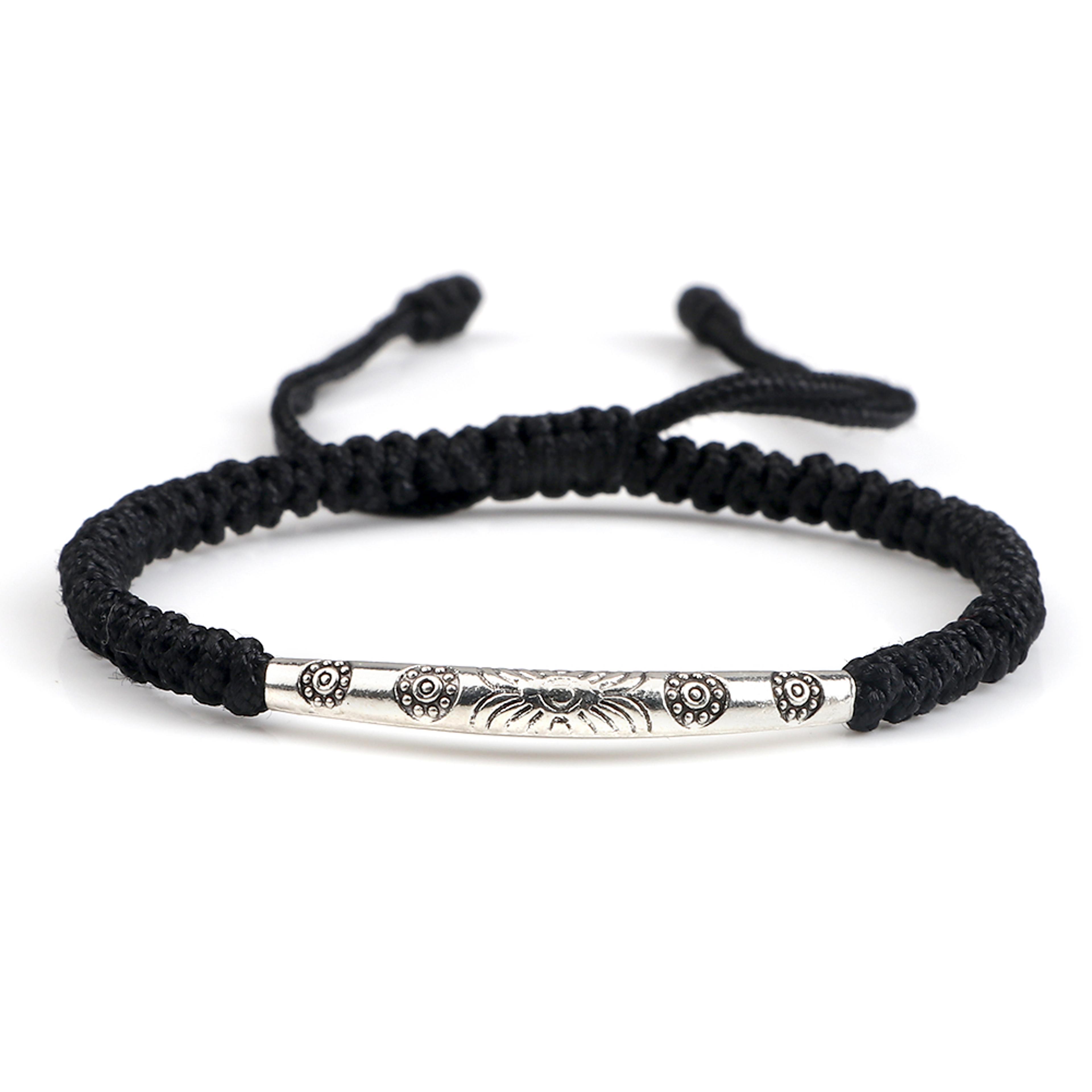 handmade bohemian woven bracelet with carved flower pendant and adjustable rope