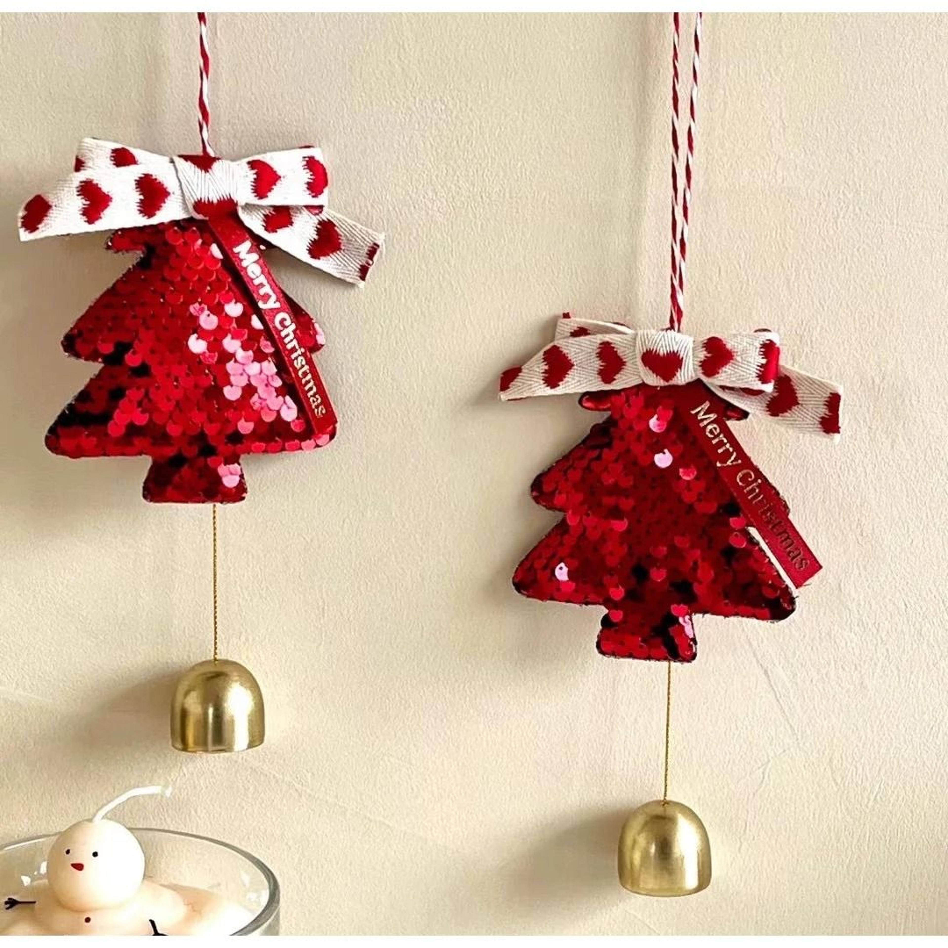 christmas tree hanging ornaments with bows and golden caps