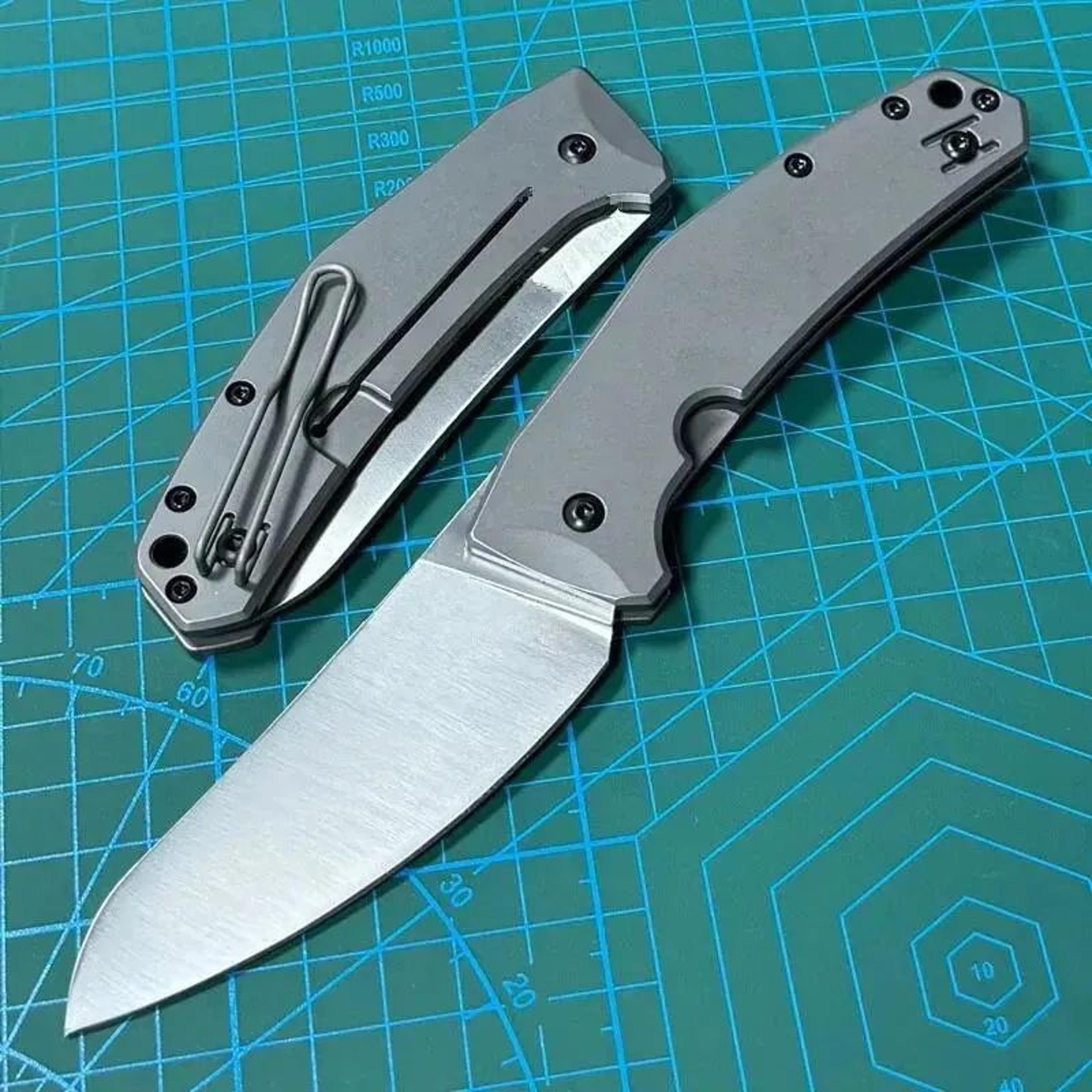 folding edc pocket knife with steel blade and gray titanium handle