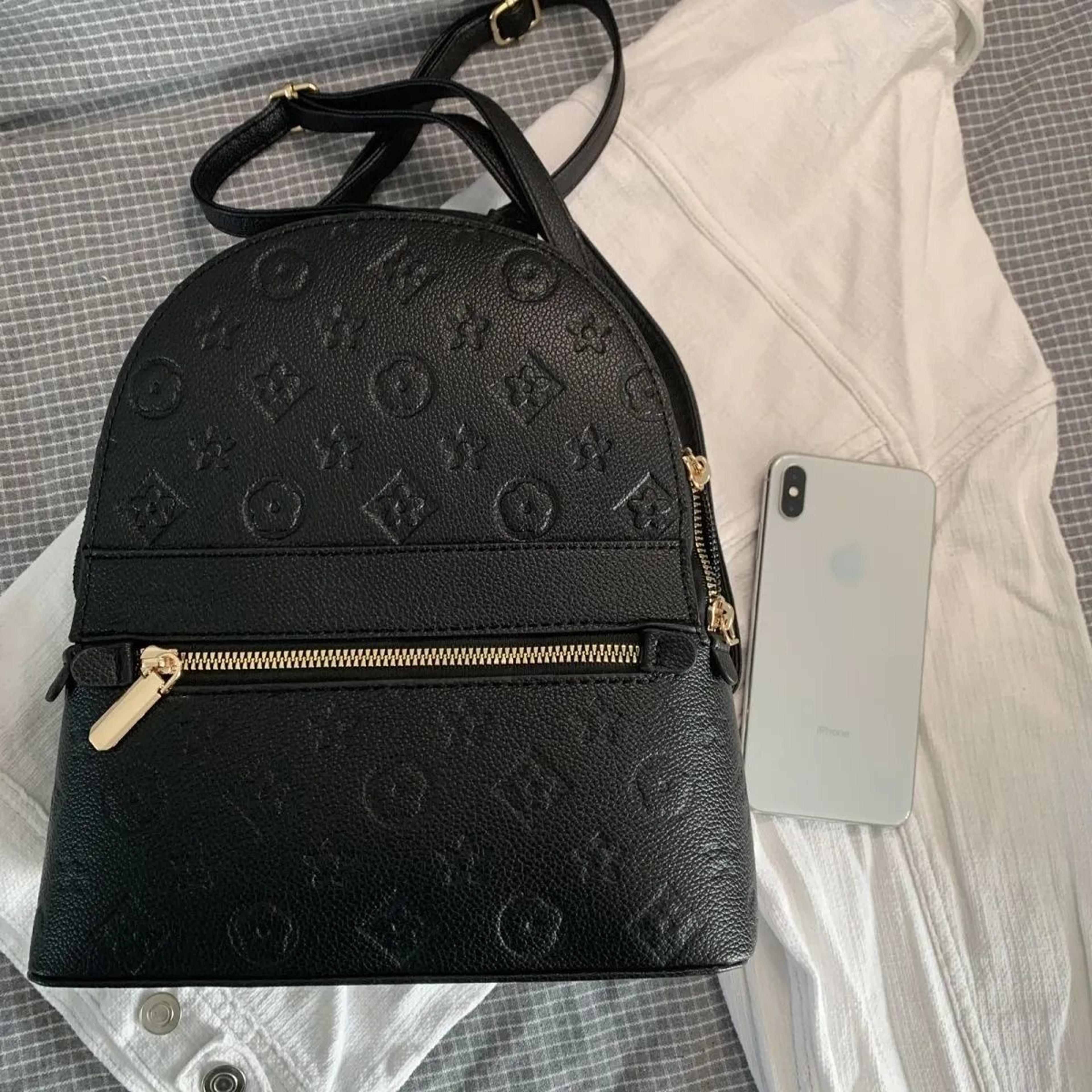 women mini faux leather backpack with embossed letter detail and front zipper pocket