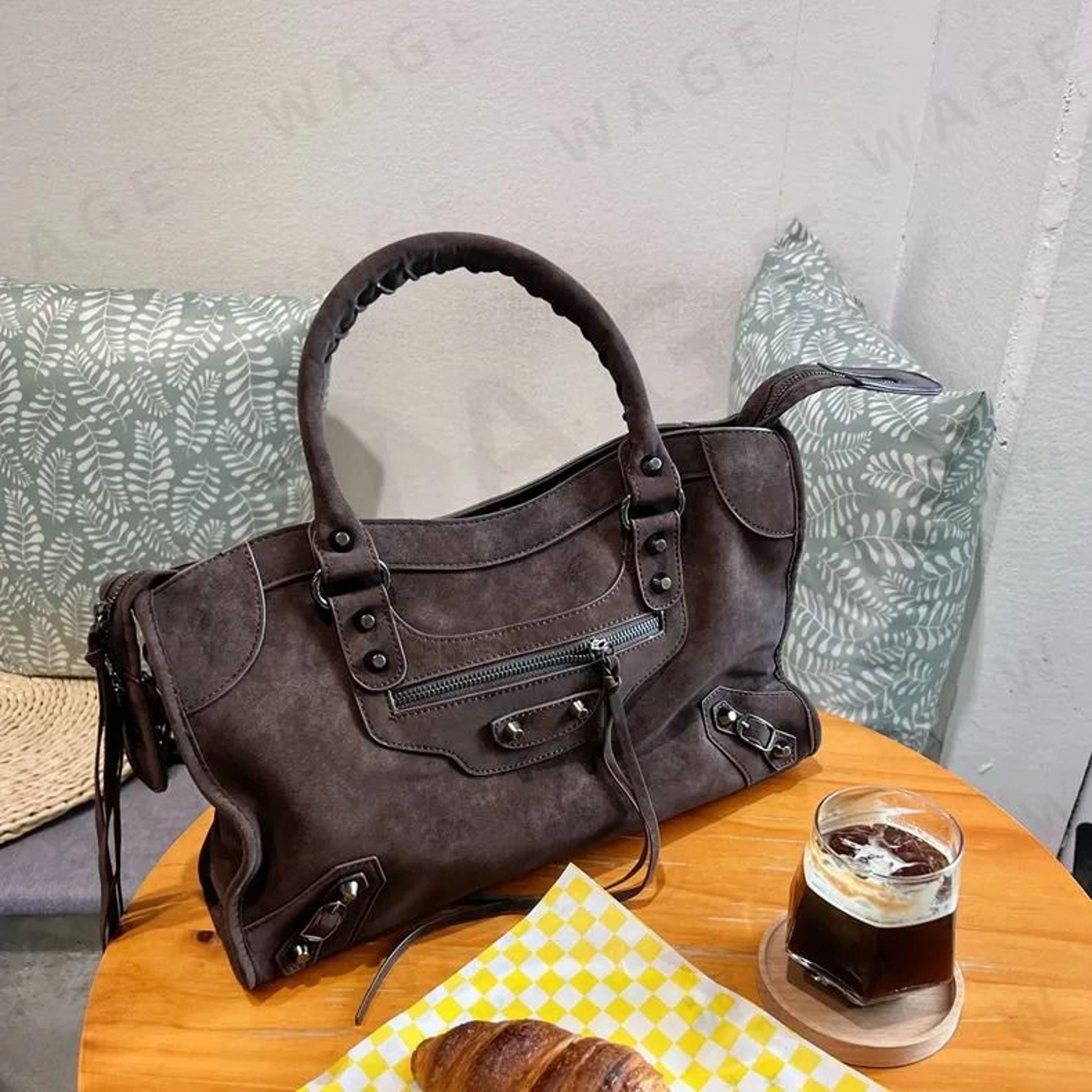 suede fringe moto bag with studded detail and convertible carrying styles