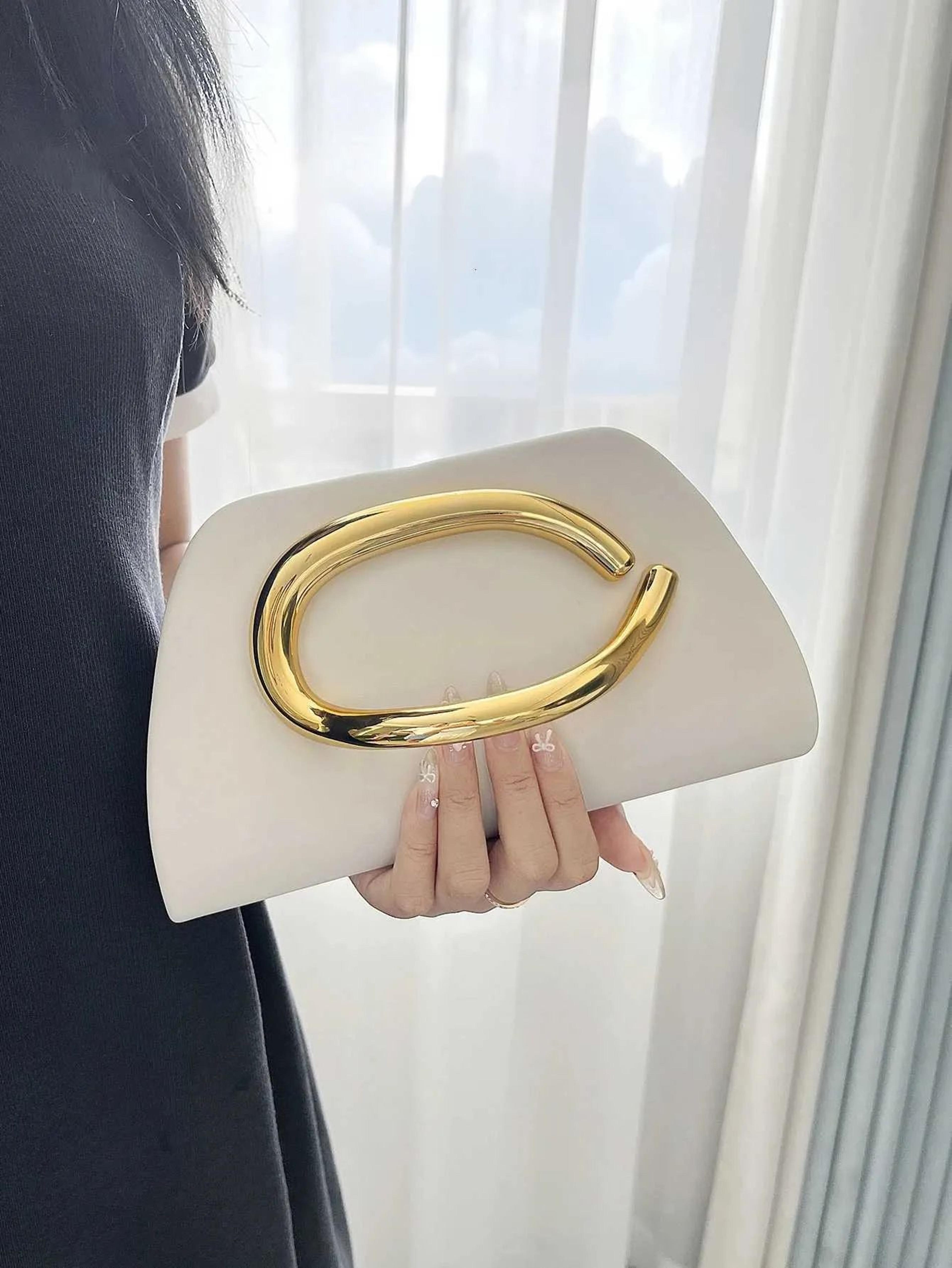 women gold evening crossbody bag with magnetic closure and chain strap