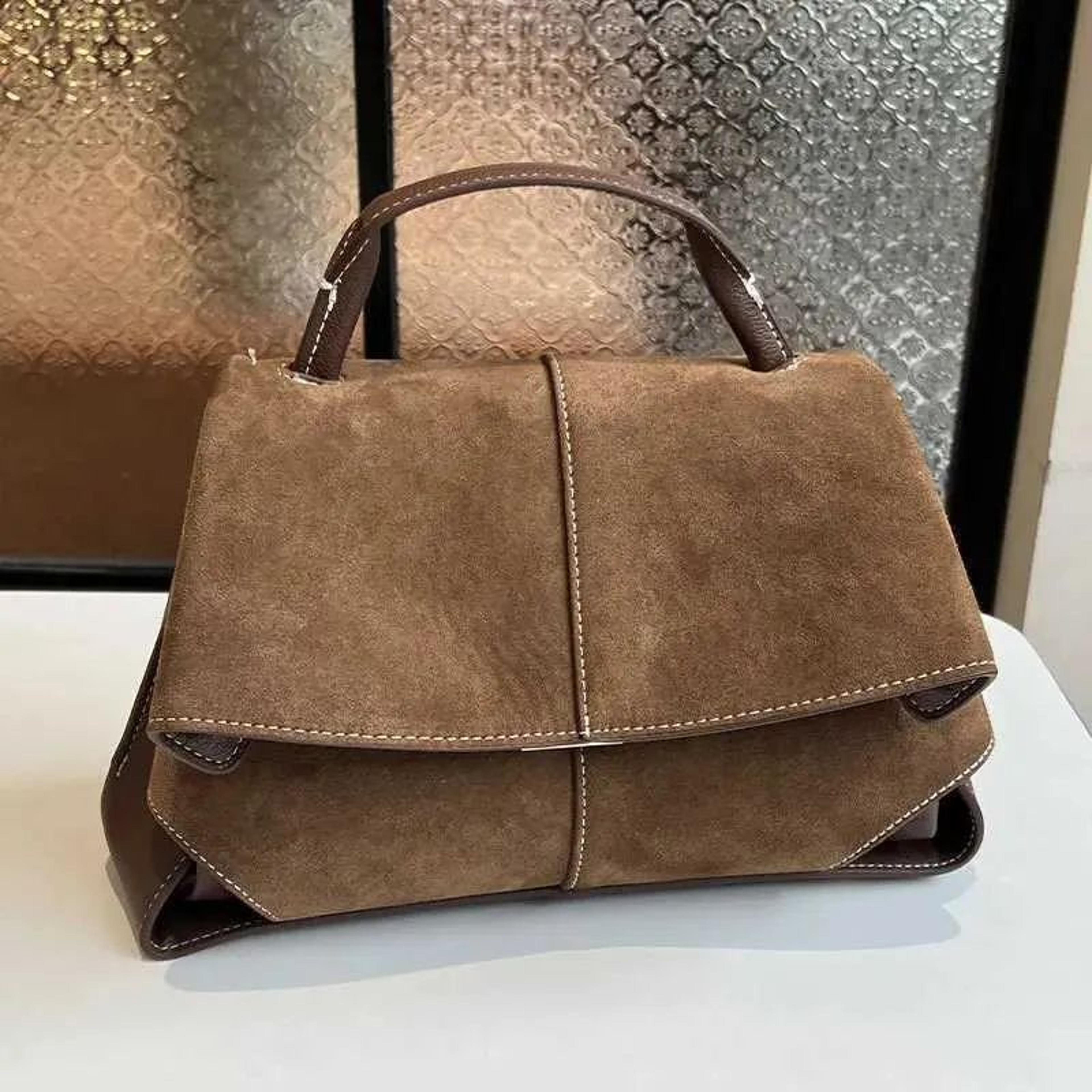 womens suede shoulder bag with flap closure and trapezoid design