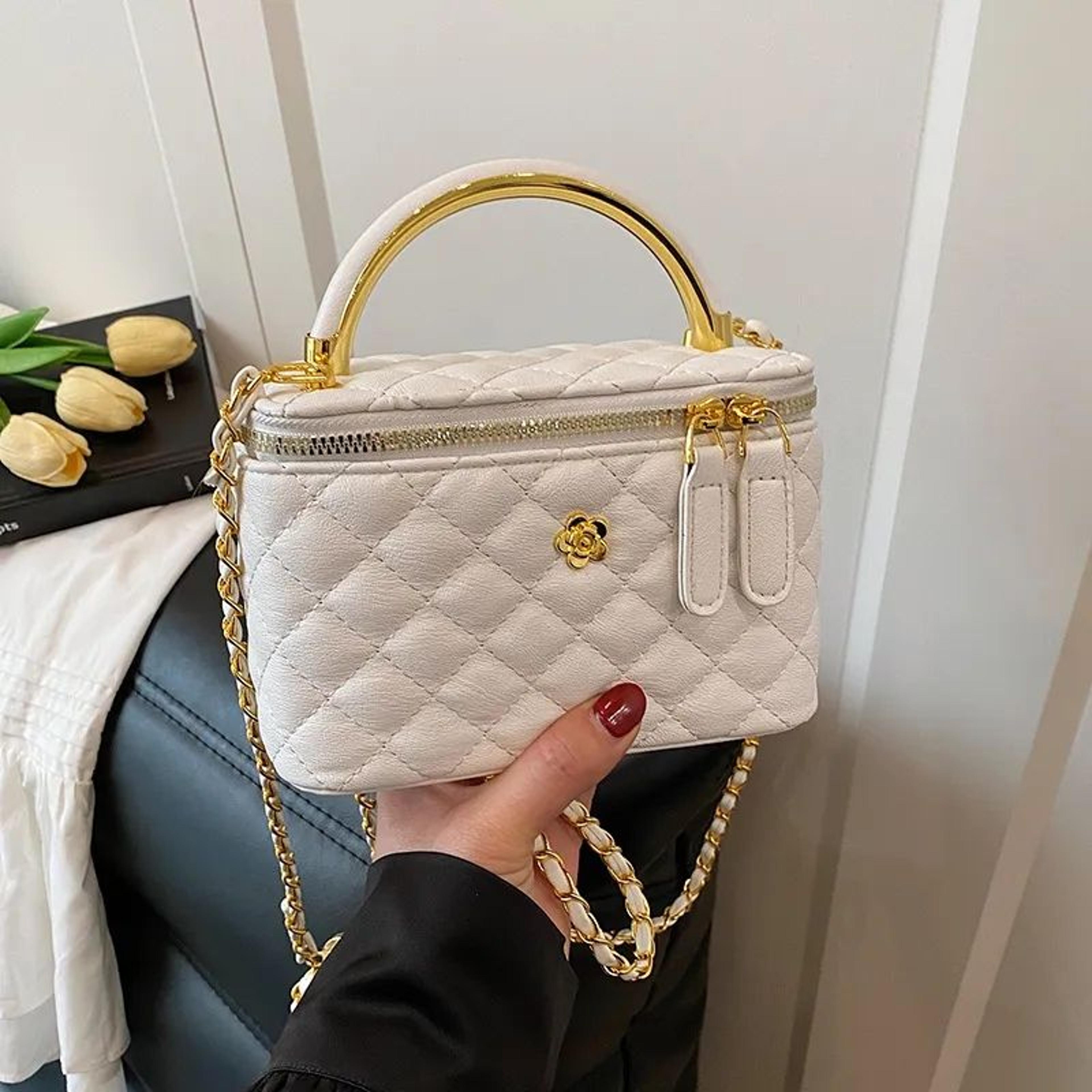 quilted floral crossbody bag with gold chain strap and metal flower accents