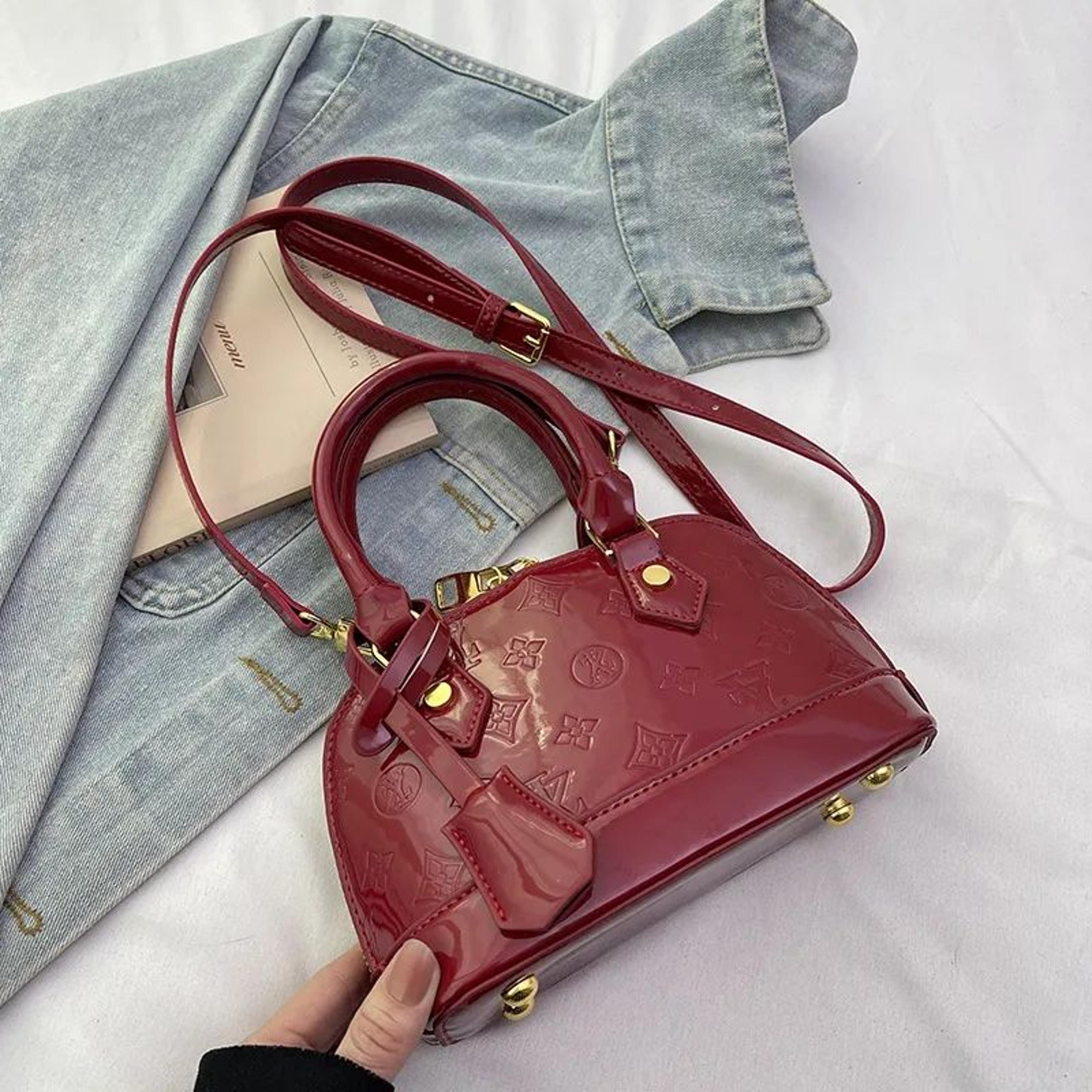 mini shell crossbody handbag with embossed lettering and patent leather finish