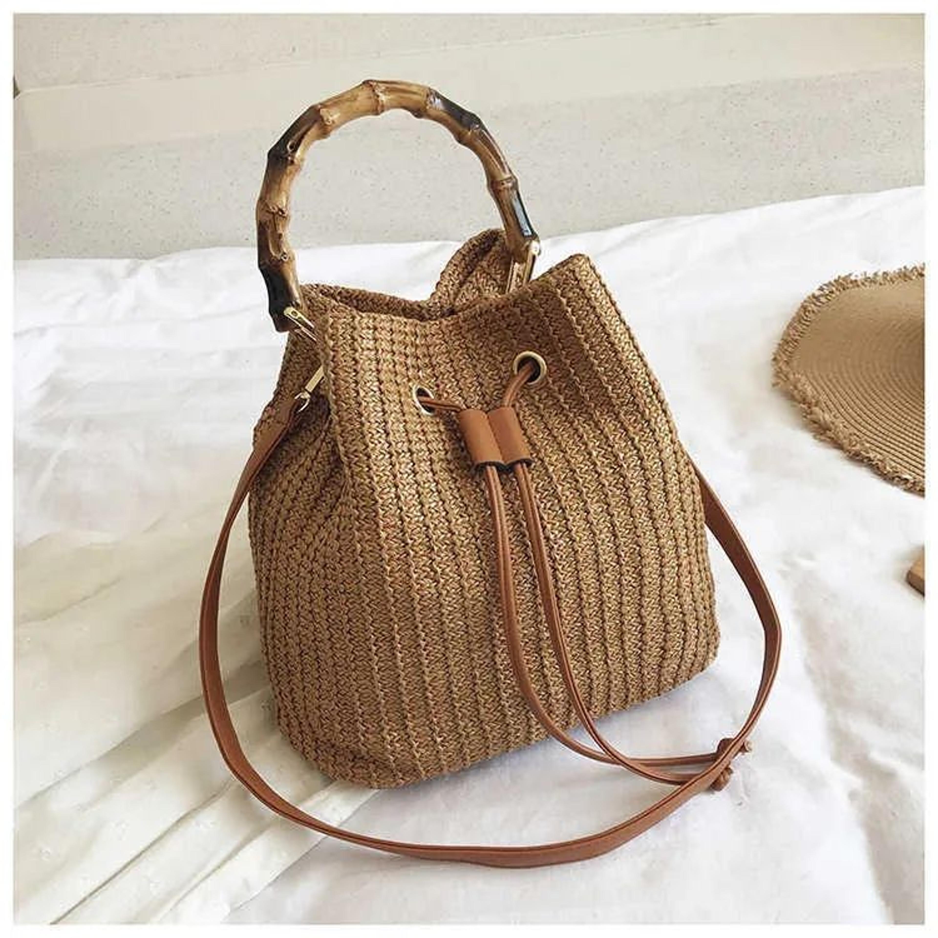 woven straw bucket bag for women with bamboo handle and crossbody design