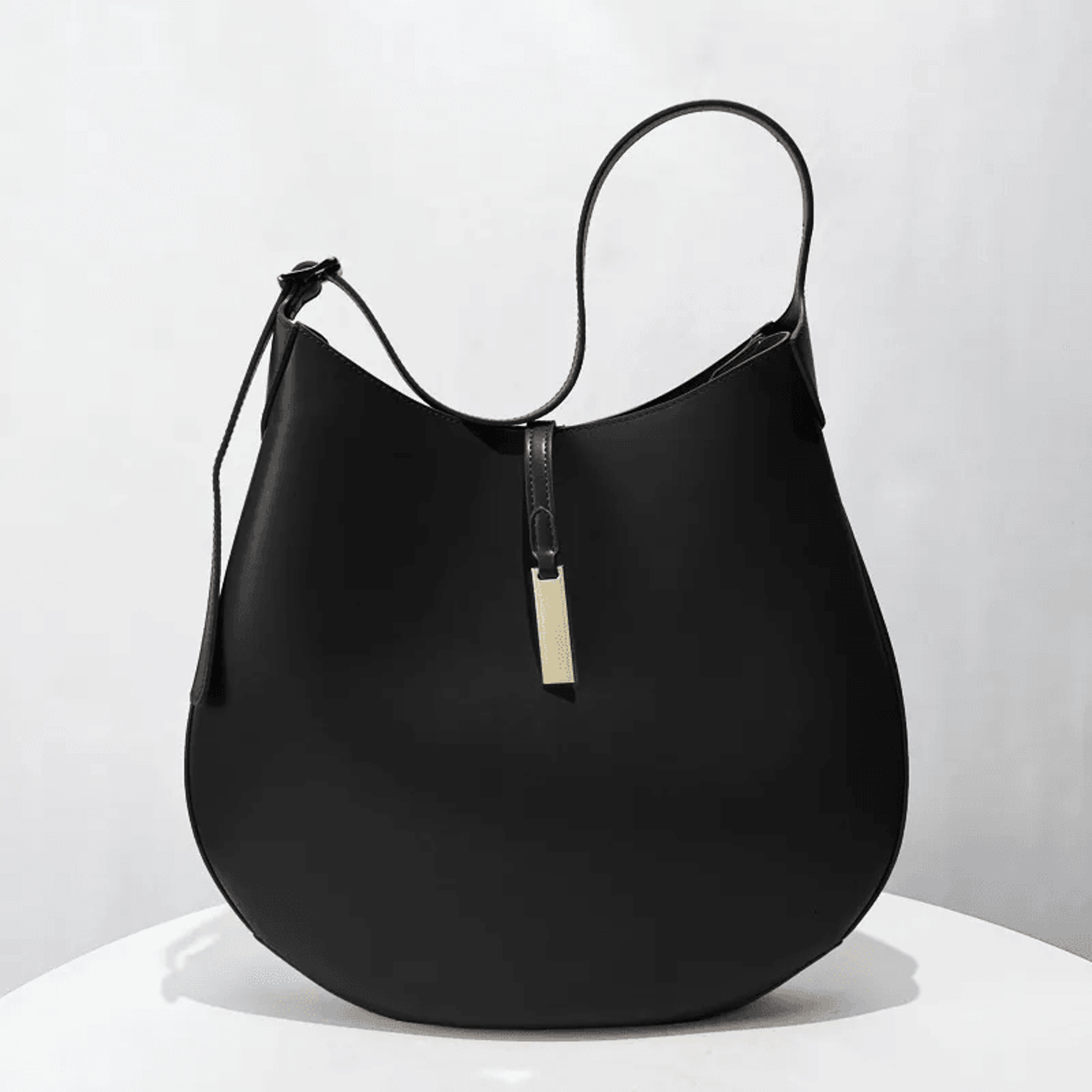 Black Minimalist Hobo Bag With Gold Bar Accent And Adjustable Strap 1