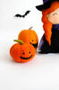 Felt orange Halloween pumpkins near the felt witch with a broomstick