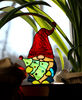 Red-gnome-cap-made-of-beautifully-textured-clear-glass-through-which-the-sun's-rays-pass-a-bright-element-of-the-stained-glass-suncatcher-A-gnome-with-a-Christm