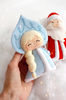 Felt Snow maiden and grandfather Frost toys against the background of snow