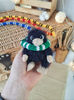 stuffed black niffler toy in Ravenclaw scarf