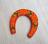 red souvenir wooden horseshoe hand-painted