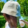 Lightweight and breathable linen bell hat. White and beige bucket hat from the sun.