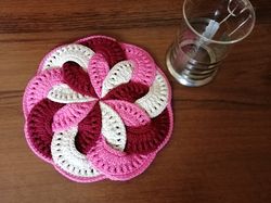 Round pink napkin, a stand for hot food.