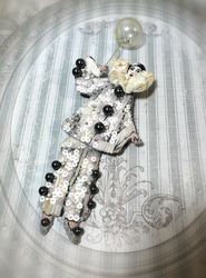 Large white Pierrot brooch with a balloon, legs sway when walking.