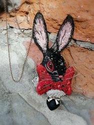 Embroidered pendant or brooch with an evil rabbit