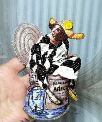Embroidered brooch portrait of Harlequin in a tin can. To you from Venice.