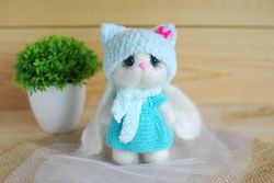 Crochet toy bunny is amigurumi toy.  White handmade bunny in dress.