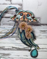 Turquoise and pink embroidered necklace with butterfly and eucalyptus flowers.