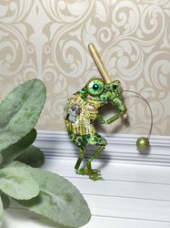 Embroidered brooch with a green frog. Number 12 with wooden bat and pearl ball.