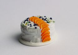 Miniature orange cake with berries, dollhouse food for dolls at 1:12 scale