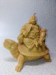 Candle figurine. Buddha on a turtle. Wax candle. Beeswax candle. Statuette.