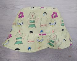 Comic cotton bucket hat for travel, beach, sun protection. Funny and cute summer clothes. Yellow designer bucket hat.