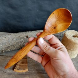Handmade wooden spoon from natural apricot wood for serving or cooking