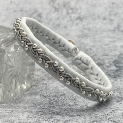Female Sami leather bracelet with silver beads. A narrow braided bracelet for a woman. Scandinavian style jewelry.