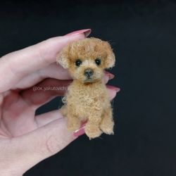 A poodle. A small crocheted dog. Amigurumi. A miniature pet. A custom-made dog.A red-haired puppy. Dog souvenir gift