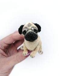 Pug. Miniature little crocheted pug. Cute dog. Amigurumi puppy. Funny pet. A fat dog. A puppy as a souvenir