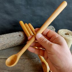 Handmade wooden spoon from natural beech wood with long handle for stirring cocktail or ice cream or milkshake spoon