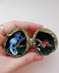 Miniature terrarium made of walnut shell with a chameleon crocheted