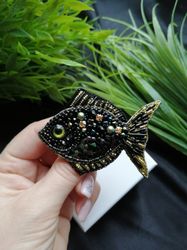 A brooch in the form of a fish, handmade marine jewelry with beads and crystals