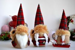 Family of three Christmas gnomes in hats, Christmas table decoration