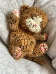Knitted toy realistic sleeping tabby kitten