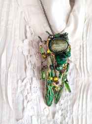 Embroidered green brooch or pendant on a chain beetle with serpentine and malachite. The brooch is called Spring shower.