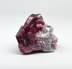 Cherry tourmaline crystal in association with zeolite and lepidolite.