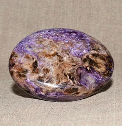 A polished pebble made of charoite