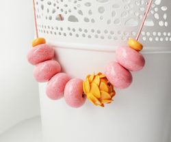 Peach pink beaded necklace with orange flower. Floral minimal necklace. Handmade enamel jewelry