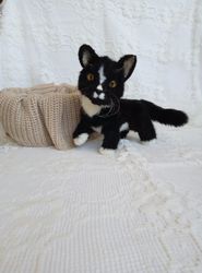 Realistic plush kitten in black and white by photo