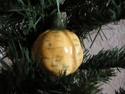 Ceramic pumpkin. Halloween ornament. Christmas tree toy