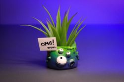 Cute little monster with flower and eyes green-blue pot omg